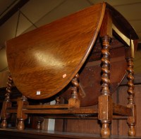 Lot 1313 - A 1920s oak barleytwist dropleaf dining table