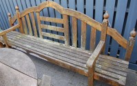 Lot 1325 - A stained and slatted teak sectional long...