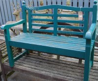 Lot 1327 - A green painted slatted teak two seater garden...
