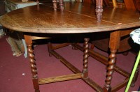 Lot 1281 - A 1920s barleytwist dropleaf dining table