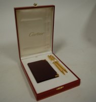 Lot 441 - A boxed Must de Cartier gold plated ballpoint...