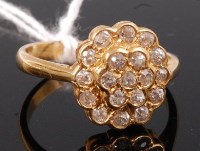 Lot 353 - An 18ct gold and diamond set flower head...