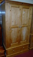 Lot 1071 - A modern pine wardrobe, having a moulded...