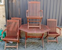 Lot 1095 - A modern four piece stained teak patio suite,...