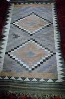 Lot 1116 - A Persian woollen rug, having two rows of five...