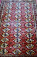 Lot 1117 - A Persian woollen rug, having three rows of...