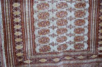 Lot 1120 - A Persian woollen Bokhara rug having three...