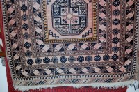 Lot 1121 - A Caucasian woollen rug decorated with three...