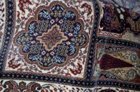 Lot 1124 - A large Persian style machine woven rug,...
