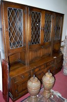 Lot 1125 - A modern moulded oak three section wall unit,...