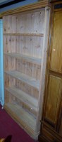 Lot 1136 - A modern pine five tier open bookcase on...