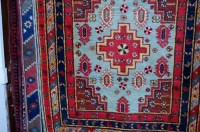 Lot 1123 - A Persian woollen rug, having two central...