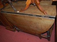 Lot 1184 - A 19th century oak gateleg table, the hinged...