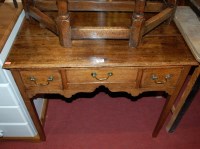 Lot 1196 - A George III oak lowboy, the rectangular...