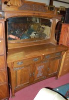 Lot 1220 - An Art Nouveau oak sideboard, having mirrored...