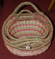 Lot 1221 - A graduated set of three multi-coloured wicker...