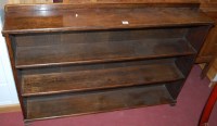 Lot 1238 - An early 20th century oak low three tier open...