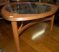 Lot 1245 - A 1970s teak coffee table, having glass inset...