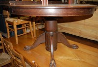 Lot 1253 - An early 20th century oak extending dining...