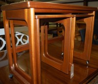 Lot 1257 - A 1970s nest of three teak occasional tables,...