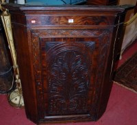Lot 1144 - A George III and later carved oak hanging...