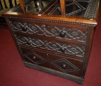 Lot 1317 - A carved oak chest having two panelled top...