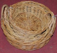 Lot 1185 - A graduated set of three wicker twin handled...