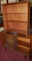 Lot 1336 - A 1970s teak bookcase enclosed by pair of...