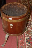 Lot 1349 - A mahogany and brass bound planter of circular...