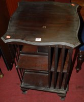 Lot 1360 - An Edwardian walnut revolving bookcase having...