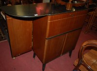Lot 1363 - A 1970s bow front bar having a faux granite...