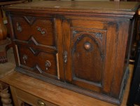 Lot 1324 - A moulded oak chest fitted with two geometric...