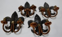 Lot 29 - A set of six cast iron fleur de lys and copper...