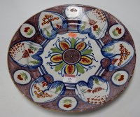 Lot 75 - An 18th century Delft charger polychrome...