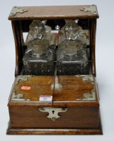 Lot 85 - A 1920s oak silver and plated two bottle...