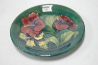 Lot 150 - A Moorcroft plate in the Anemone pattern, on a...