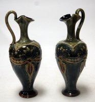 Lot 183 - A pair of Royal Doulton stoneware ewers, each...