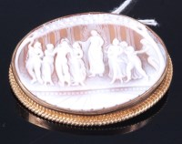 Lot 304 - A carved shell cameo brooch, depicting muses...