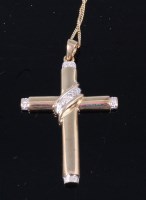 Lot 321 - A 9ct gold and diamond set cross pendant, on...