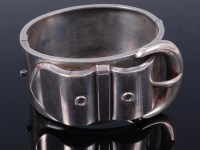Lot 327 - A silver hinged bangle in the form of a belt
