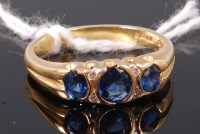 Lot 340 - An 18ct gold three sapphire set ring, the...