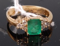 Lot 341 - An 18ct gold, emerald and diamond cluster ring,...