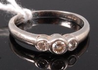 Lot 344 - A platinum and diamond three stone ring,...