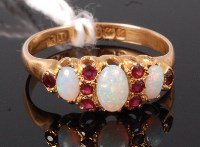 Lot 354 - An 18ct gold, opal and ruby set dress ring,...
