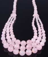 Lot 380 - A ladies rose quartz three string necklace,...