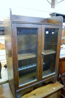 Lot 1424 - A small early 20th century oak double door...