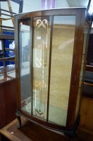 Lot 1440 - A 1930s beech bowfront single door glazed...