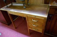 Lot 1441 - A faded walnut kneehole desk having brushing...