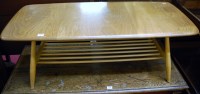 Lot 1193 - An Ercol blond elm low coffee table having...