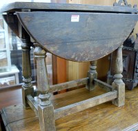 Lot 1199 - A small oak drop flap occasional table
